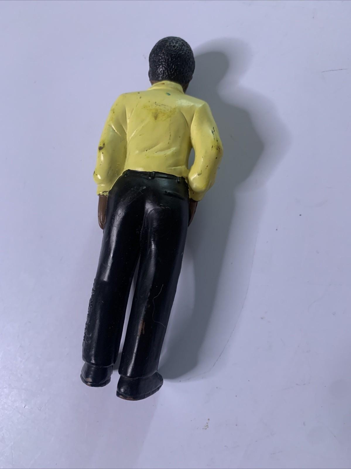 LakeShore 1994 Male Black Figure Yellow Shirt