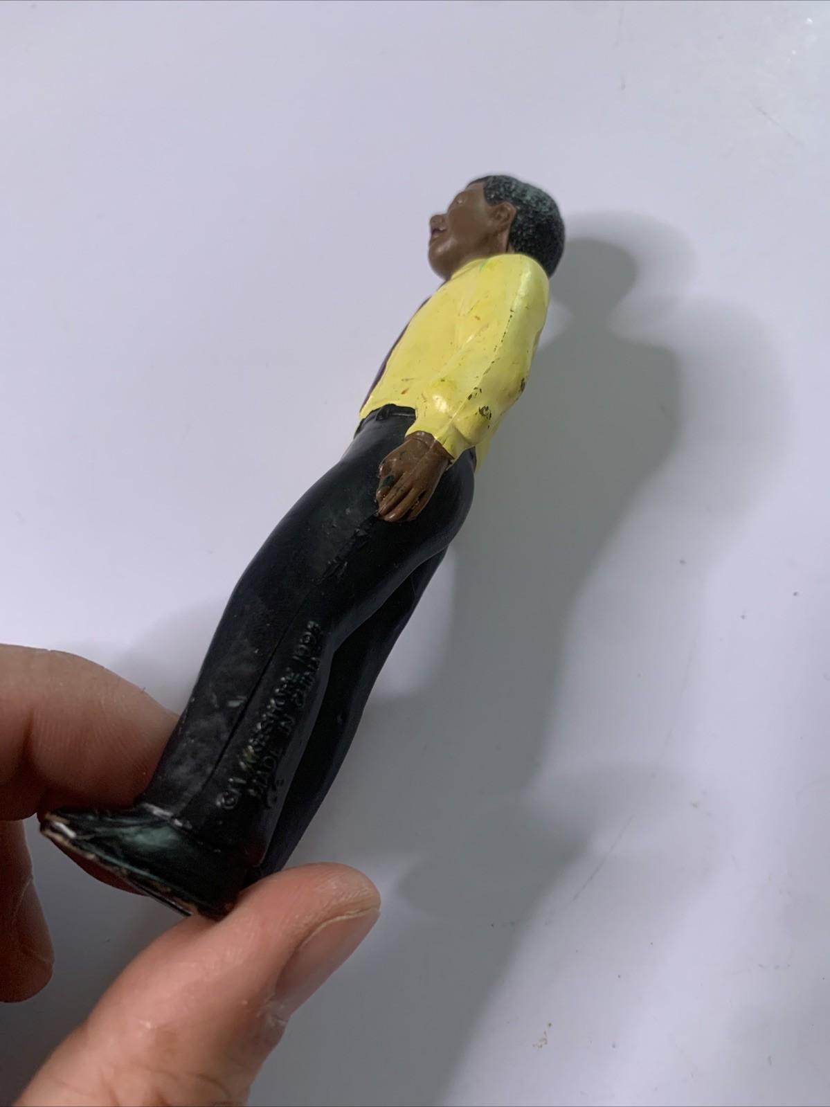 LakeShore 1994 Male Black Figure Yellow Shirt