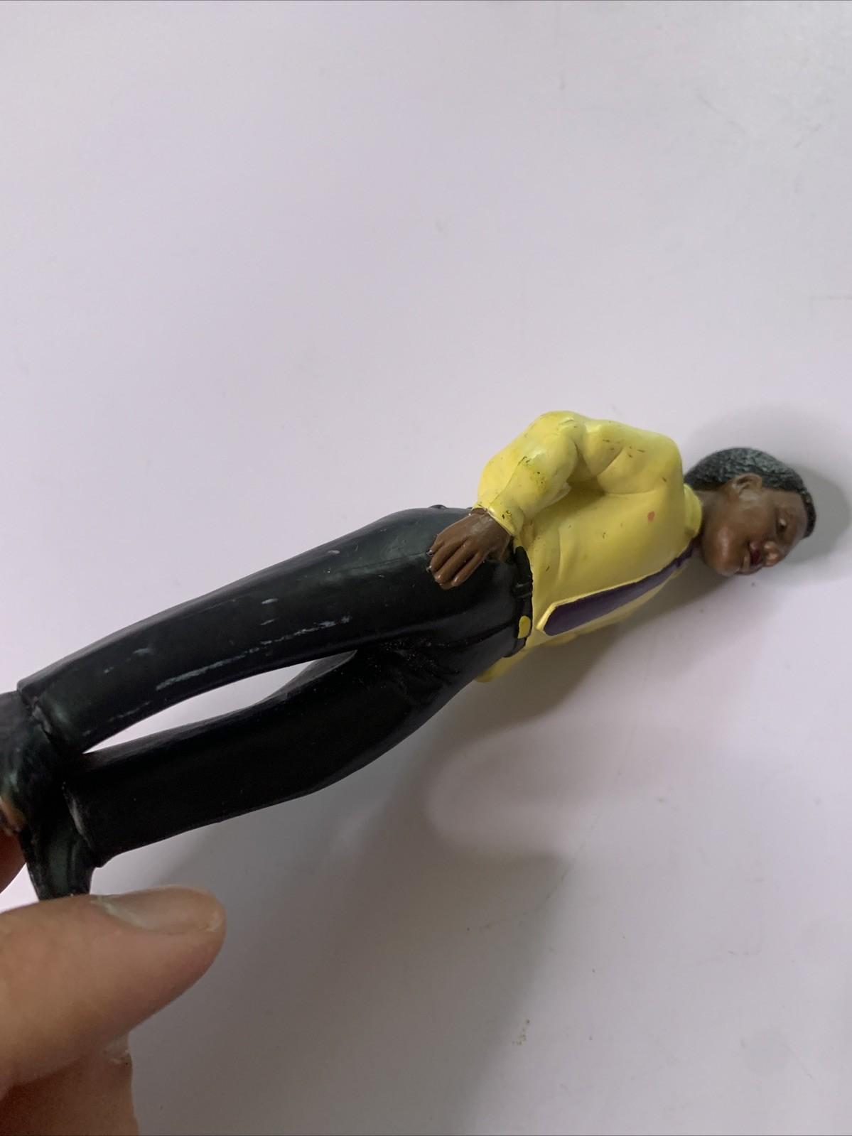 LakeShore 1994 Male Black Figure Yellow Shirt