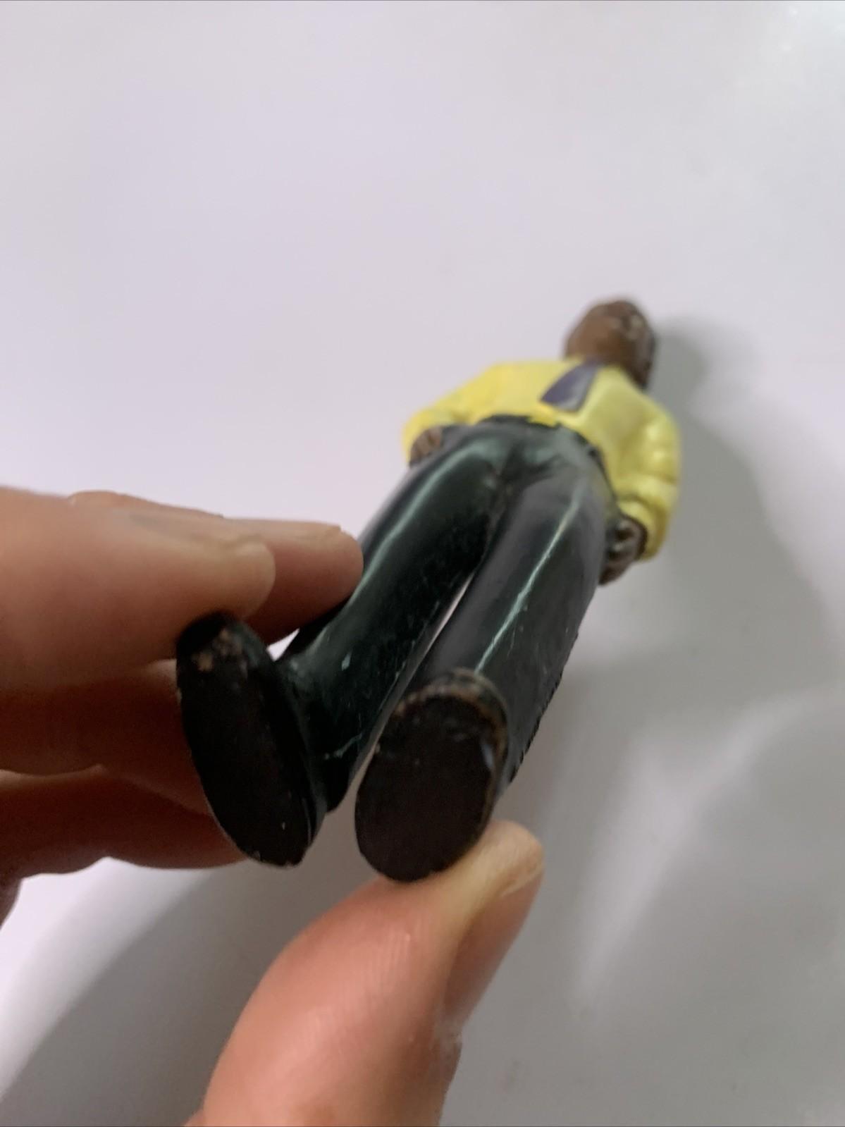 LakeShore 1994 Male Black Figure Yellow Shirt