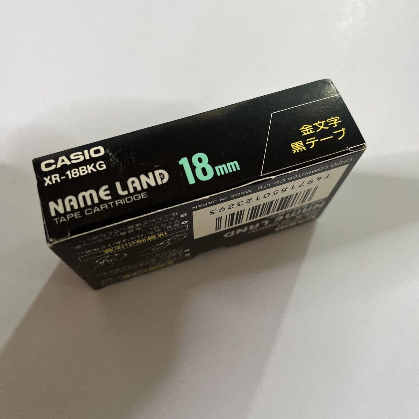 Casio Name Land Tape Cartridge 18mm Black Background Gold Text XR-18BKG  NEW