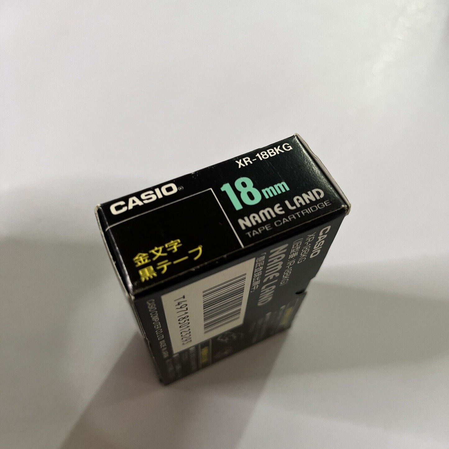 Casio Name Land Tape Cartridge 18mm Black Background Gold Text XR-18BKG  NEW